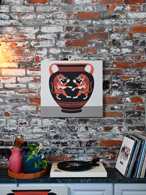 This design depicts a clay vase with a dueling pair of tigers and meander patterns in a modern, eclectic home.