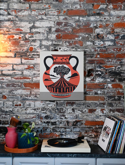 This is a canvas print design of an ancient clay vase depicting a volcanic eruption. The vase is accented with unique patterns like lightning bolts and meanders. The art is displayed in a modern eclectic home.