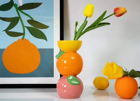 Colorful stacked citrus shaped ceramic decorative vase in orange, yellow, and pink