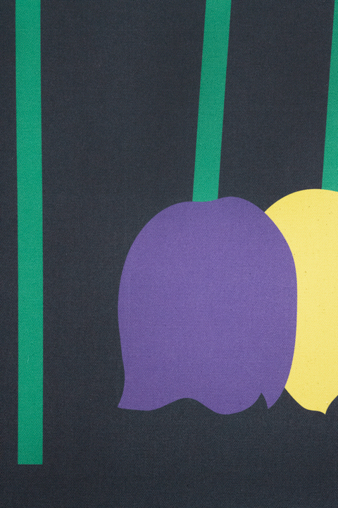 Close up of a piece of canvas artwork featuring a black background with green lines and purple and yellow shapes depicting wilted tulips.
