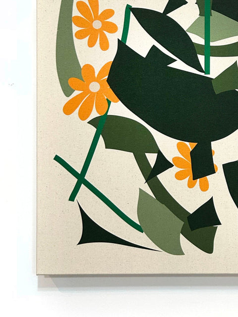 Close up of abstract canvas print with orange flower design and green geometric shapes on natural canvas