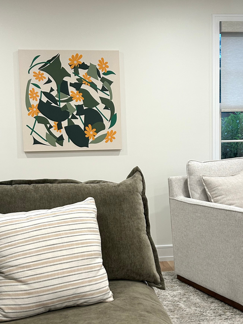 Living room with abstract floral art piece on the wall