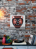 This design depicts a clay vase with a dueling pair of tigers and meander patterns in a modern, eclectic home.