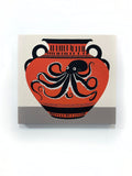 This design includes a large octopus depicted on an ancient clay vase, accented by unique marks and patterns.