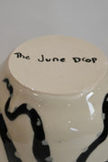 Bottom of vase with handpainted details and brand name "The June Drop"