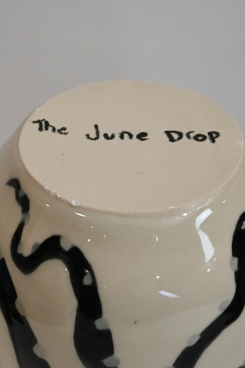 Bottom of vase with handpainted details and brand name "The June Drop"