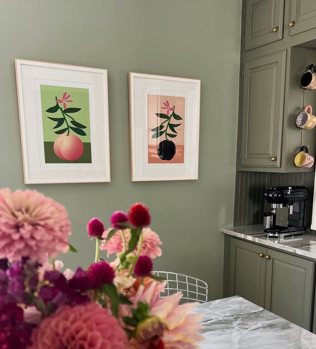 Charming country kitchen nook with colorful pop art in frames with white mat borders
