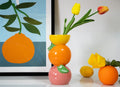 Colorful stacked citrus shaped ceramic decorative vase in orange, yellow, and pink