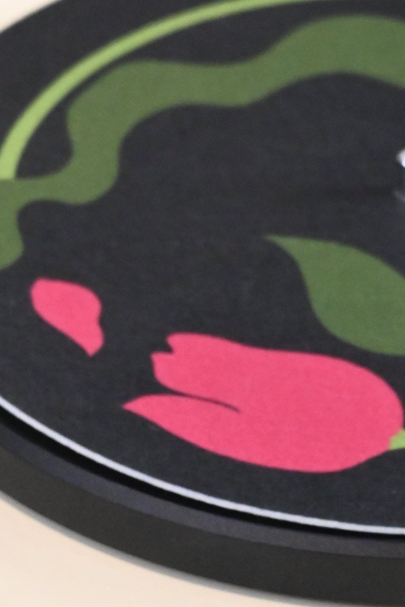 Close up of pink and green tulip record player slipmat design