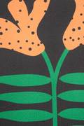 A piece of canvas contemporary art with black background featuring orange lily flowers with green leaves and black dots