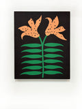 A piece of canvas contemporary art with black background featuring orange lily flowers with green leaves and black dots