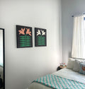 Pair of art pieces with black backgrounds featuring orange and white lily flowers with green leaves