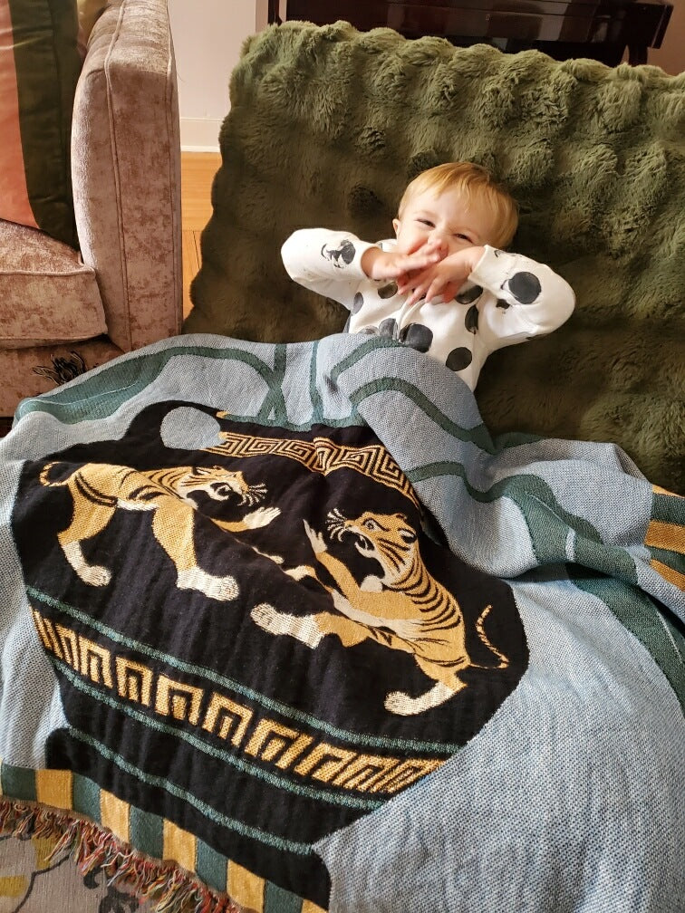 Kid with a unique tiger design blanket