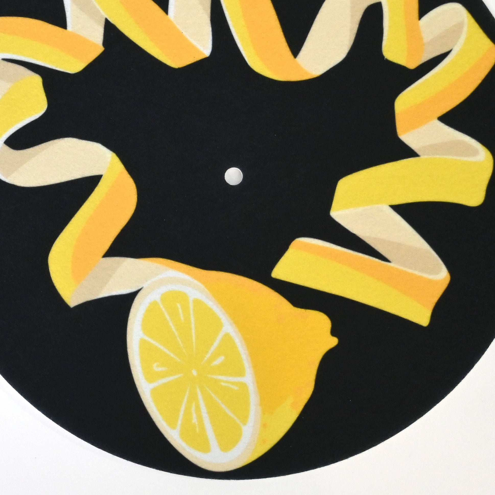 Decorative turnstile slipmat with unique lemon rind design and black background 