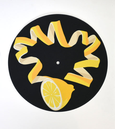 Decorative turnstile slipmat with unique lemon rind design and black background 