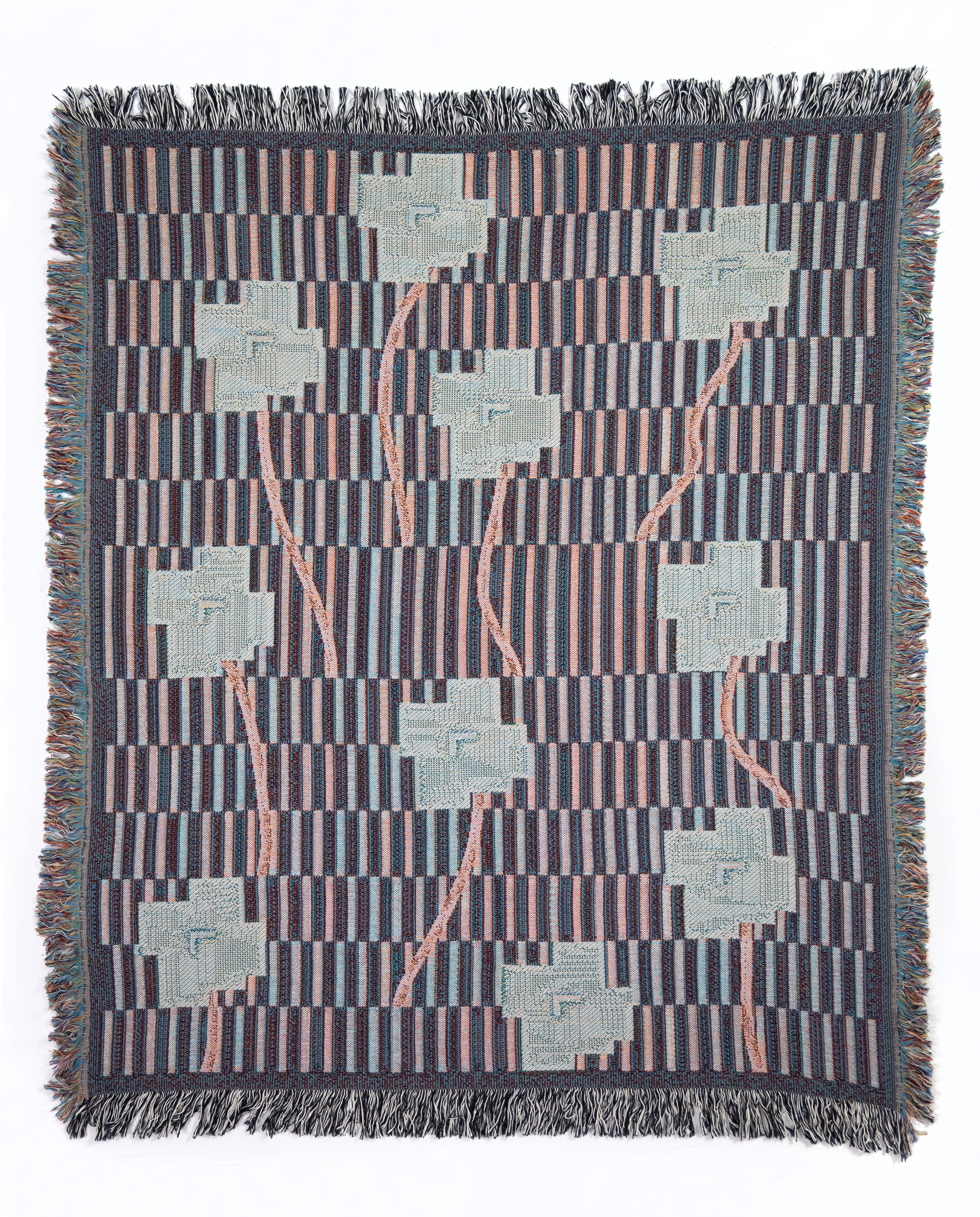 Reverse side of a soft woven blanket with geometric blue and red pattern on a white background