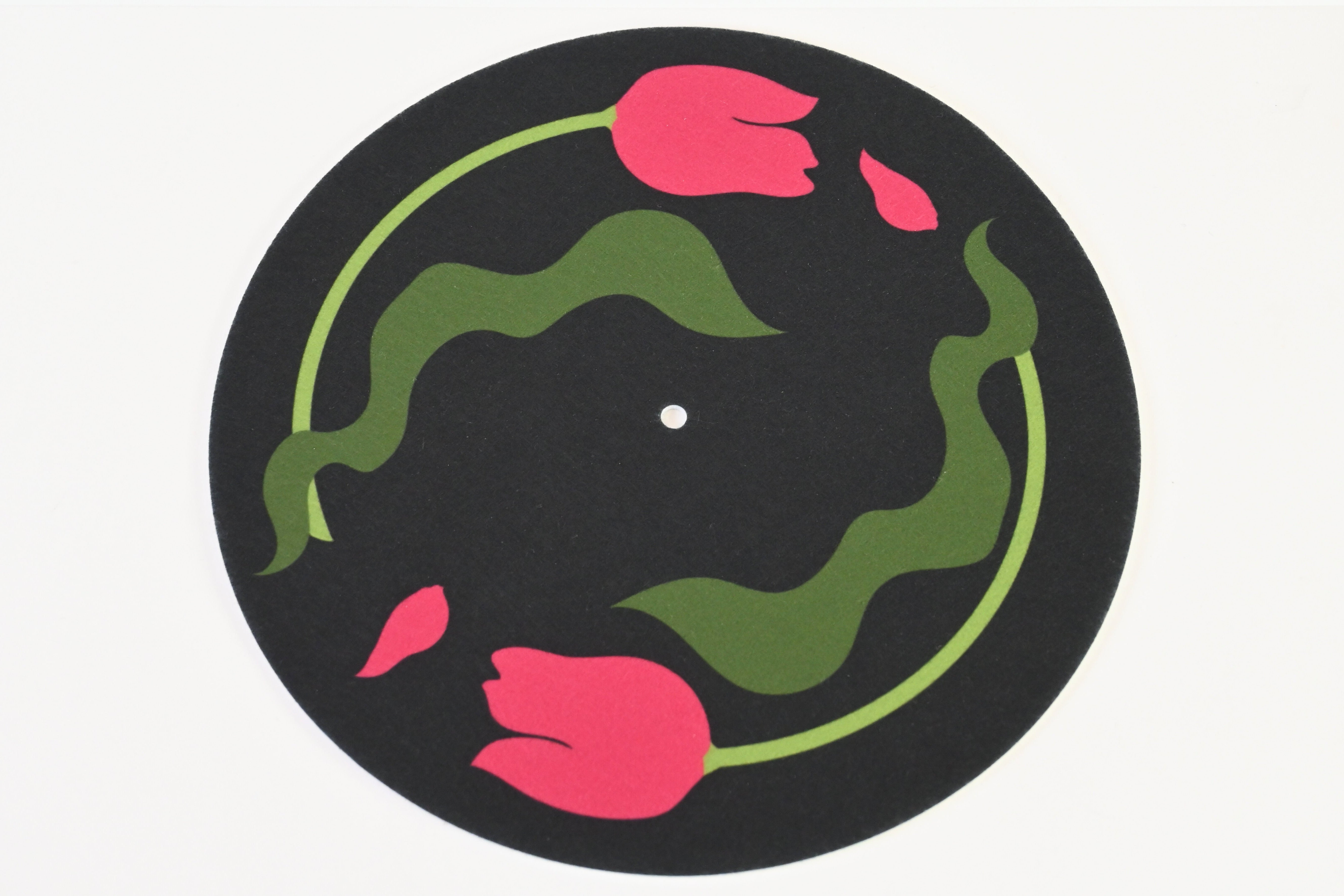 Record player slipmat design with pink tulips and green leaves on a black background