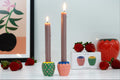 Colorful decorative strawberry holders with green, pink, blue, and yellow