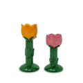 Two tulip-shaped taper candle holders with orange and pink tops on green stems against a white background